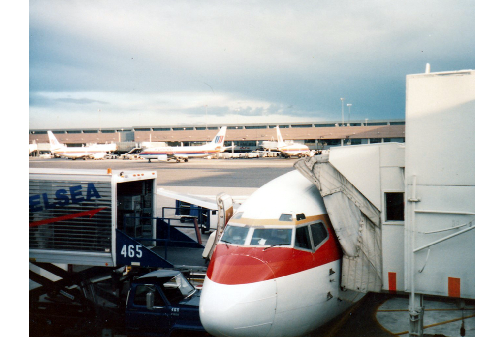 Front of plane docked at jetway