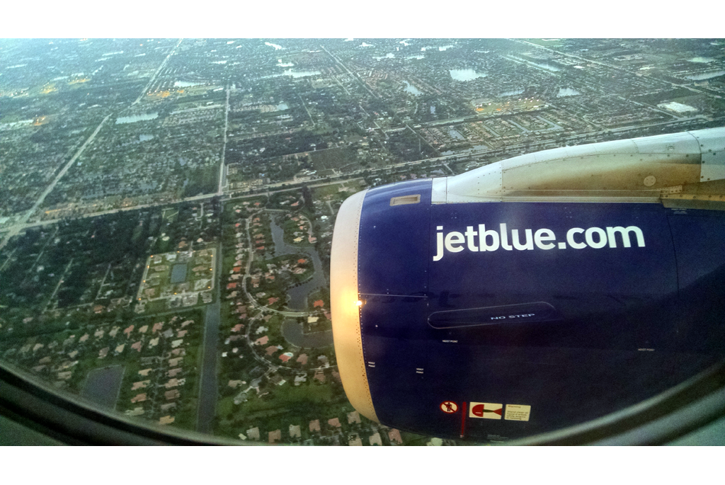 Shot of engine out of window of flying plane